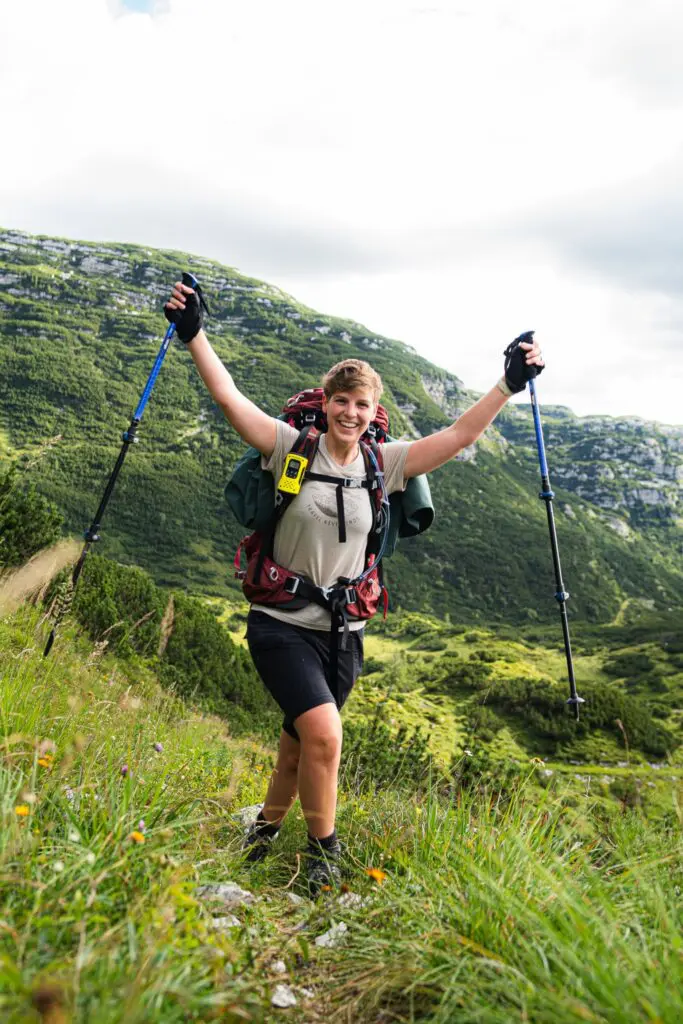 happy hiker with trekking poles in the mountains of Slovenia