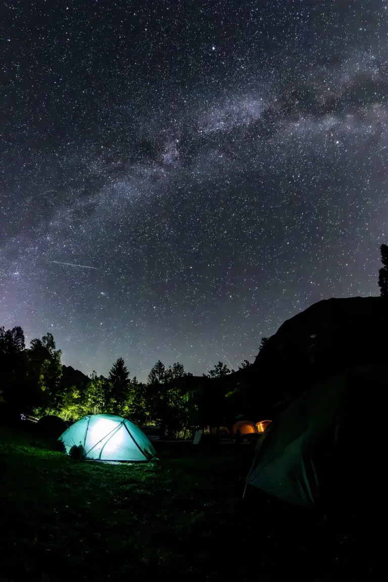 illuminated tent under the milky way in Slovenia