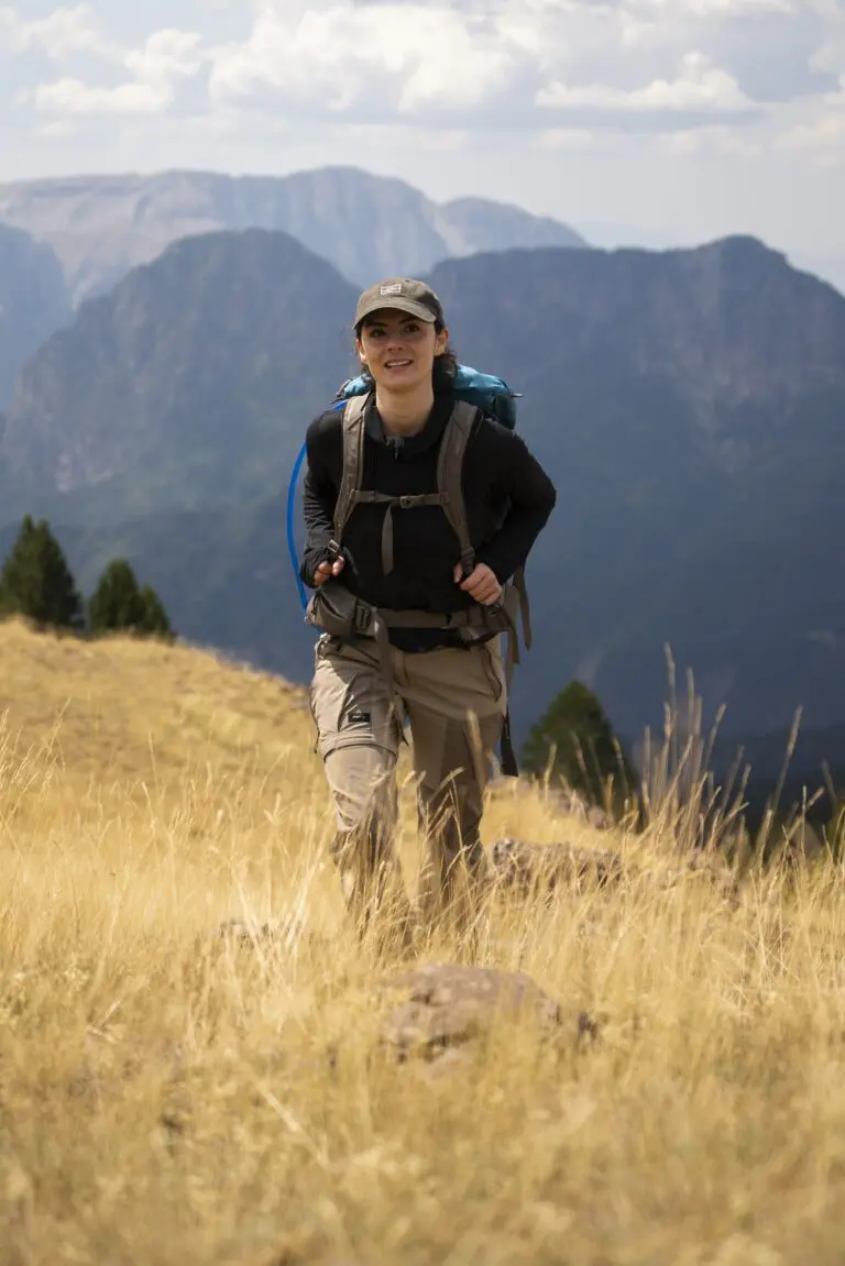 woman hiking with backpack in a mountainous landscape