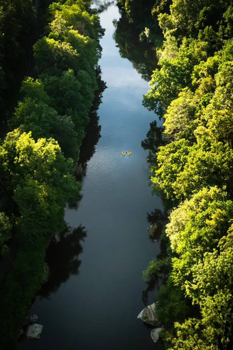 drone shot of two packrafters on a narrow river
