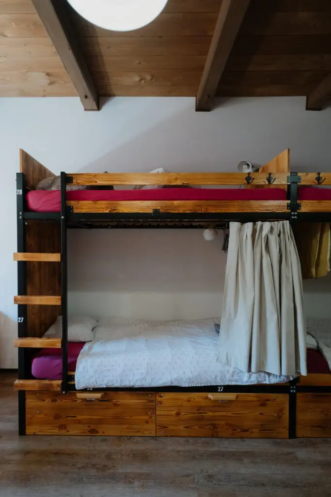 bunk beds in a hostel room with wooden accents