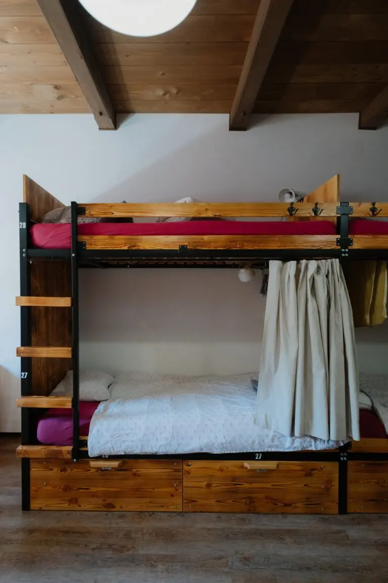 bunk beds in a hostel room with wooden accents