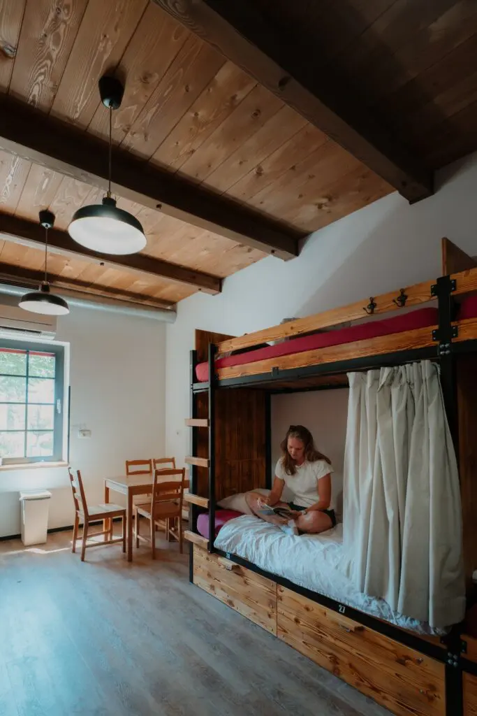 woman reading in a bunk bed in a hostel room in Slovenia